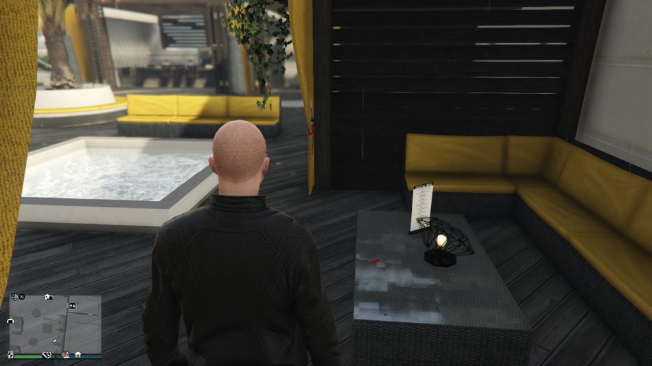 GTA Online - There is one table next to the same hot tub that is closer to the elevator. It's the second one from the elevator that you are looking for.