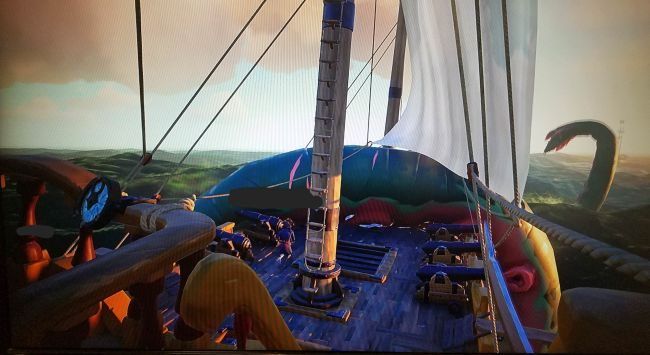 A view of a ship with a giant tentacle coming out of the water