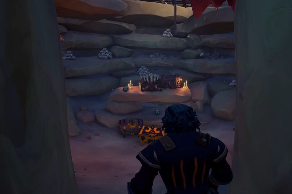 A pirate entering a cave with scattered treasure chests laying around