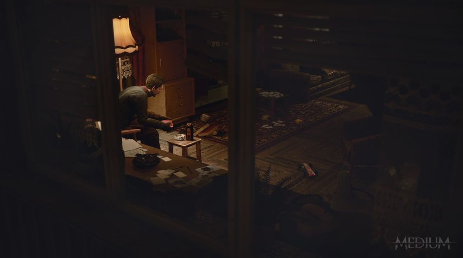 The Medium screenshot showing a man in a dark room