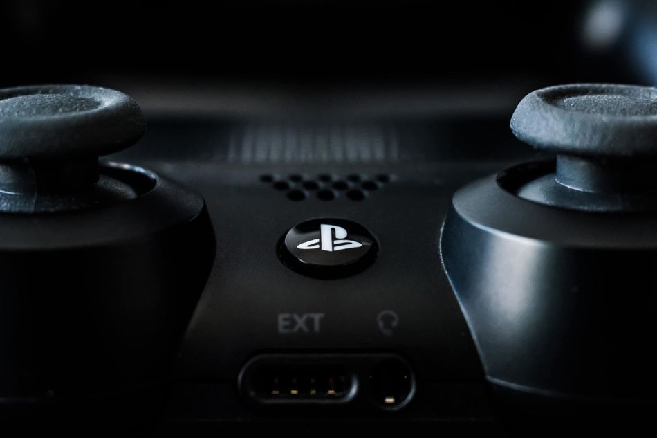 photo showing a close up of black dualshock controller