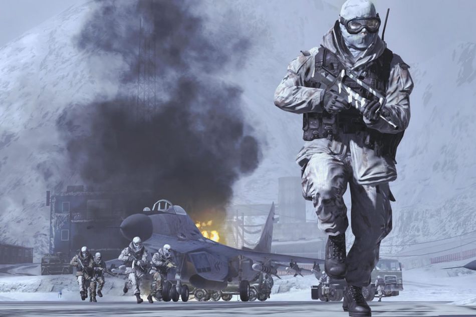 A soldier on a cold day with a burning jet fighter behind him 
