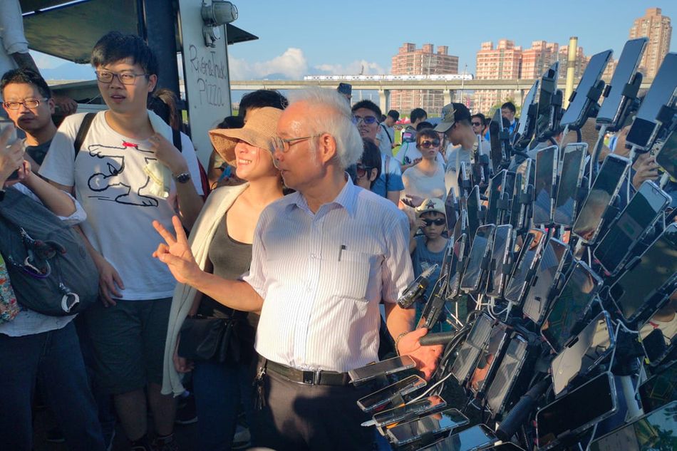 image showing Pokemon Go grandpa posing for photos 