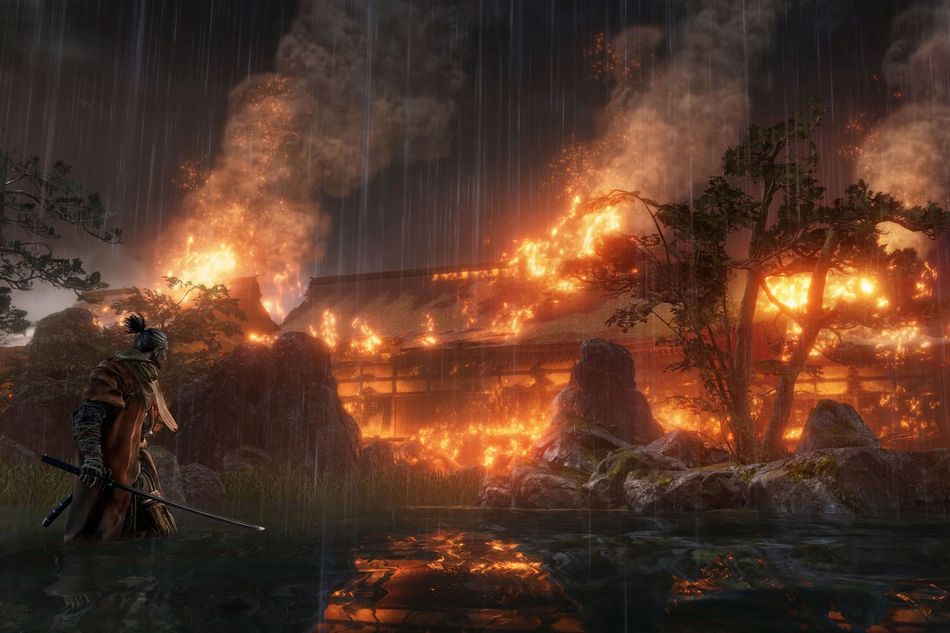 A Japanese style building burning at night in Sekiro: Shadows Die Twice