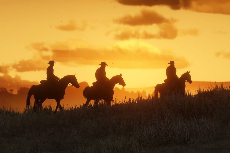 picture showing three cowboys riding horses