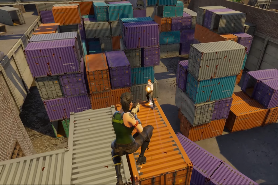 Armed woman fighting an armed man on top of large metal container