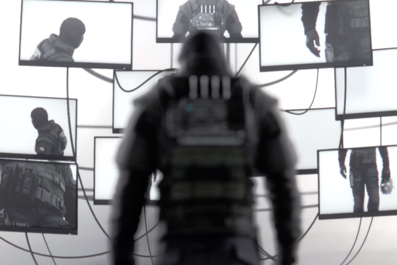 Rainbow Six Siege Operator facing multiple monitors