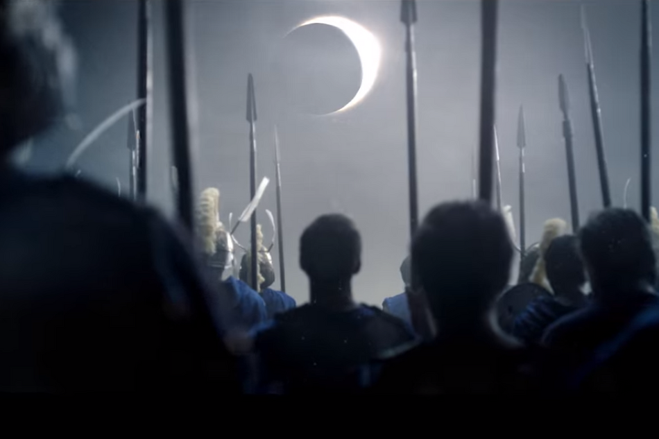 Soldiers looking at a solar eclipse