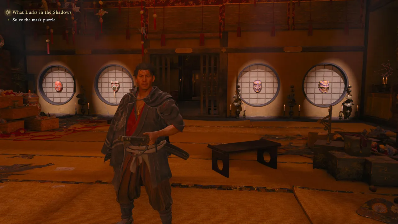 The real clue isn't above the cage, it's on the wall facing it, where each mask reappears lit from behind.