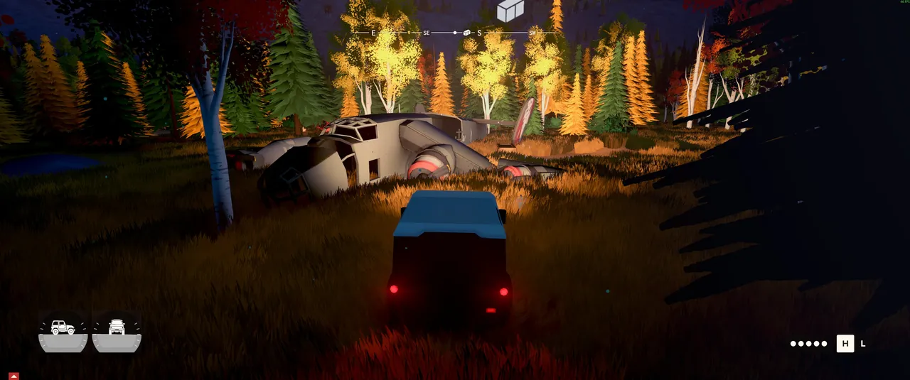 Headlights illuminate a crashed aircraft in a dark forest clearing, showing just how atmospheric over the hill's nighttime environments can get.