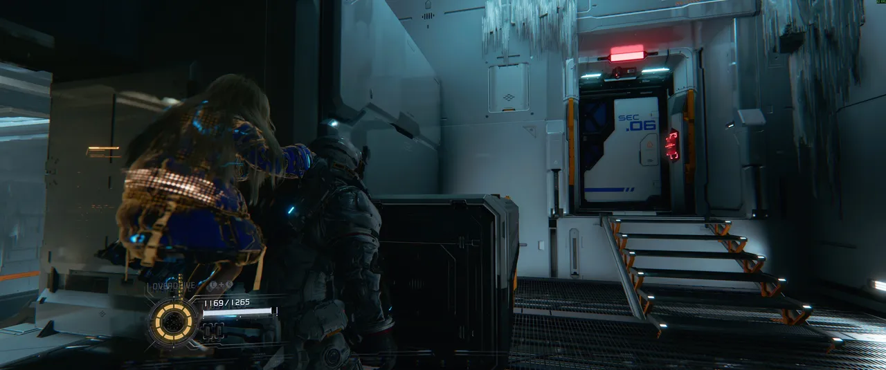 The SEC .06 door is your landmark. Don't go through it. Look to the left instead, where two climbable objects lead up to the hidden holo-wall.