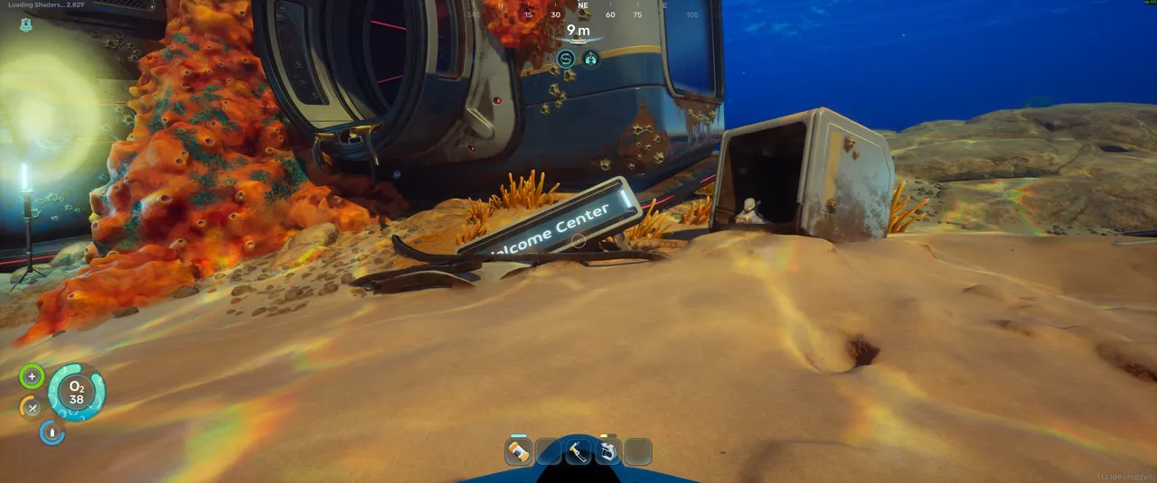 This is how you know you have found the right place. The Welcome Centre sign is half buried in the sand at the base of the building. The structure itself is dark and unpowered when you first arrive.
